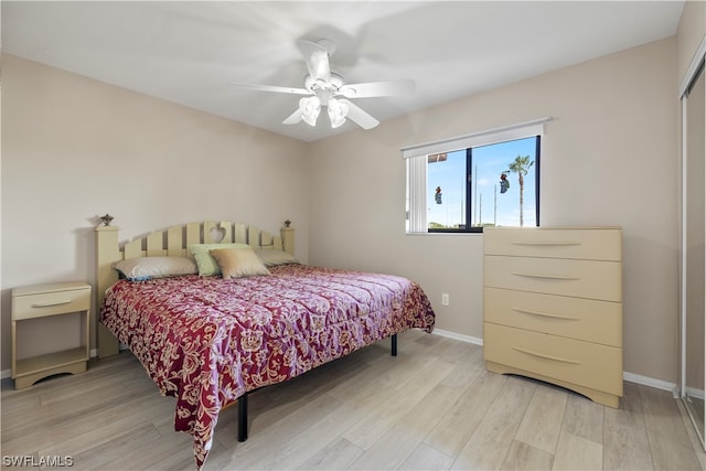 bedroom with light hardwood / wood-style floors and ceiling fan