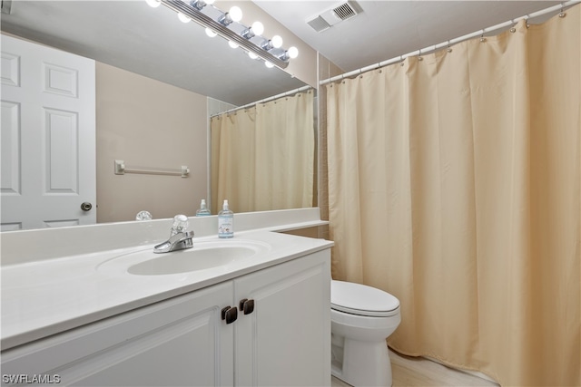 bathroom with toilet and vanity