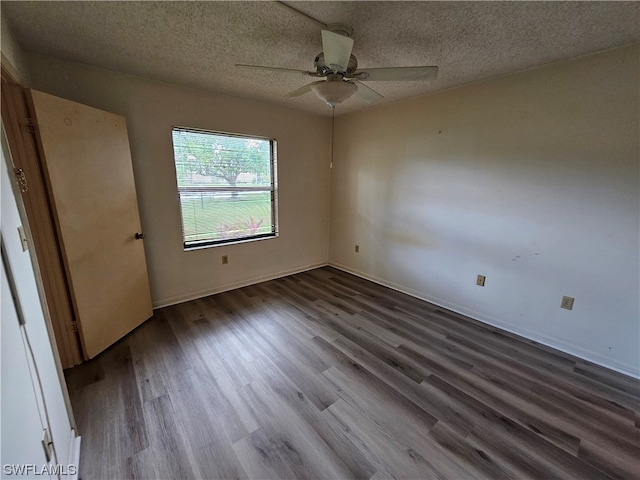 spare room featuring ceiling fan, a textured ceiling, and dark hardwood / wood-style flooring