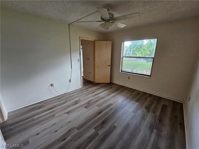 unfurnished room with light hardwood / wood-style floors, ceiling fan, and a textured ceiling