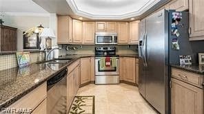 6672 Estero Blvd Unit A907, Fort Myers Beach, FL 33931 - kitchen with light brown cabinets, ornamental molding, stainless steel appliances, and dark stone countertops