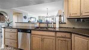 6672 Estero Blvd Unit A907, Fort Myers Beach, FL 33931 - kitchen featuring pendant lighting, sink, a chandelier, stainless steel dishwasher, and tasteful backsplash