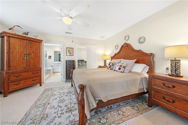 carpeted bedroom featuring connected bathroom and ceiling fan