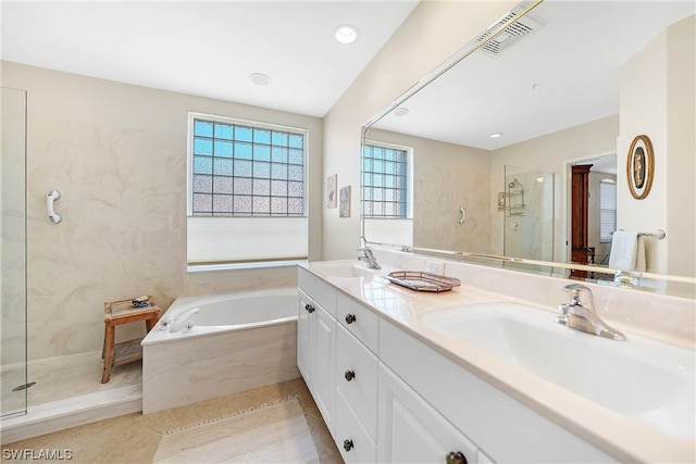 bathroom with independent shower and bath, double sink, large vanity, and tile flooring