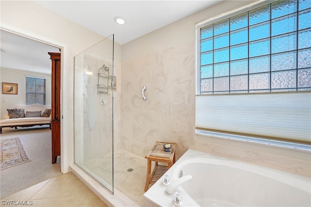 bathroom with independent shower and bath and tile flooring