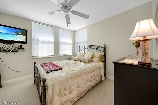 bedroom featuring light carpet and ceiling fan