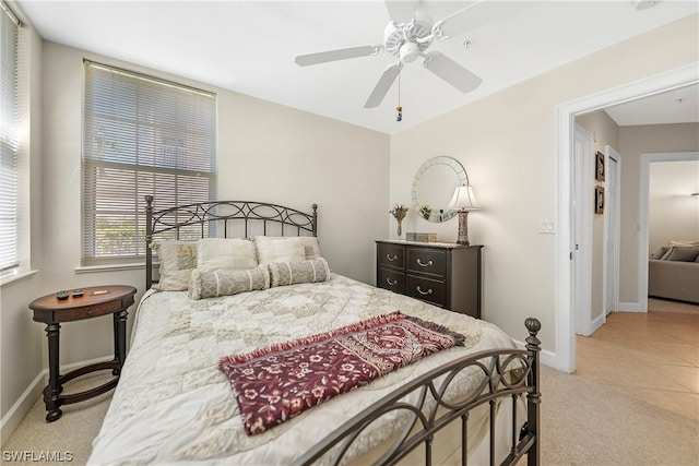 bedroom with ceiling fan and light tile floors