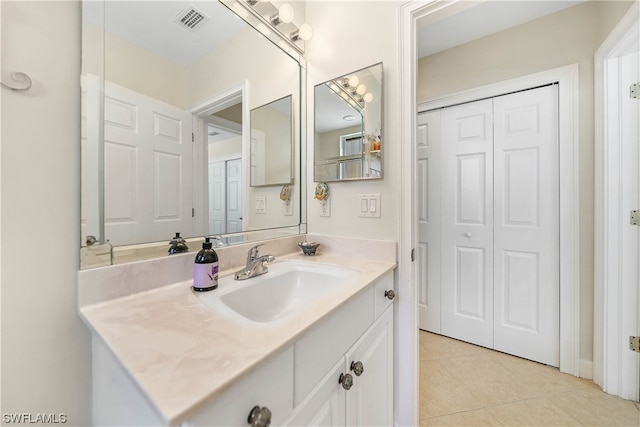 bathroom with vanity and tile flooring