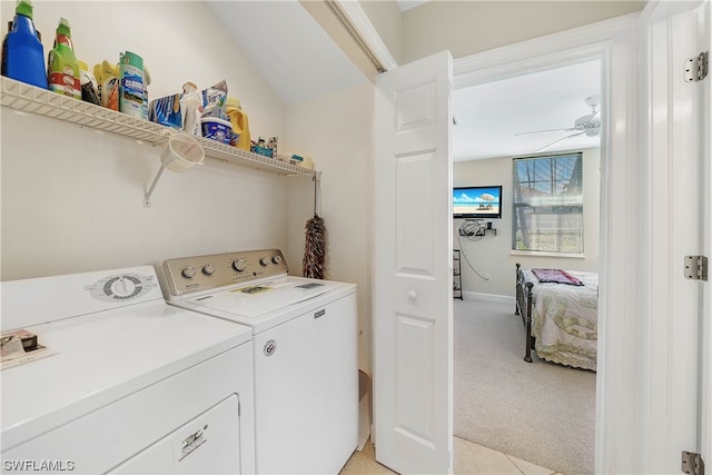 laundry room featuring washer and clothes dryer, ceiling fan, and light colored carpet