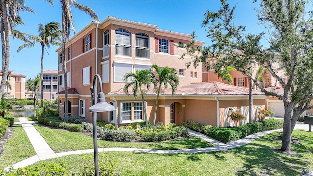 mediterranean / spanish-style home featuring a front yard