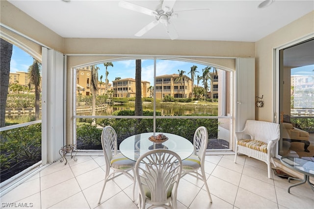 sunroom with a healthy amount of sunlight and ceiling fan