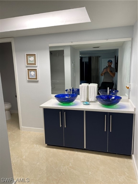 bathroom featuring vanity and toilet