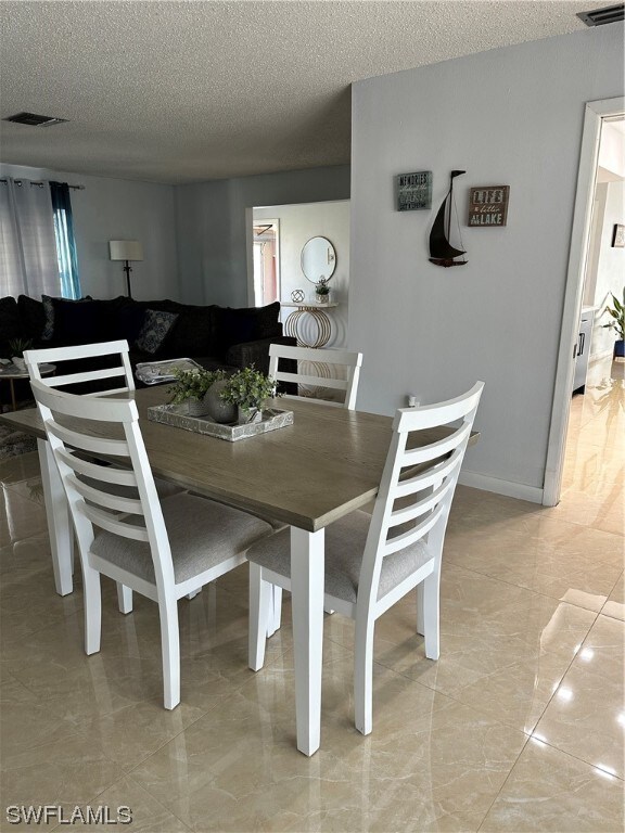 dining room with a textured ceiling