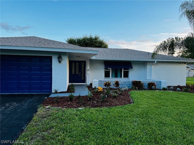 single story home with a garage and a front yard