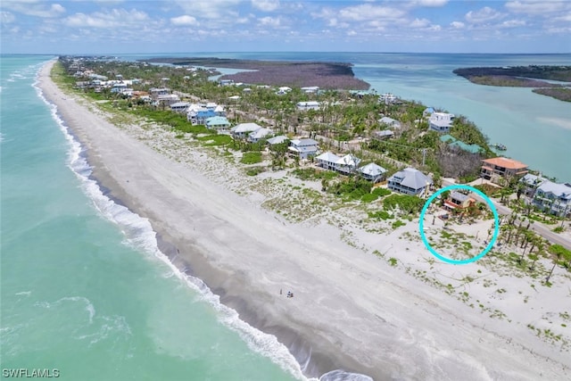 bird's eye view featuring a water view and a view of the beach