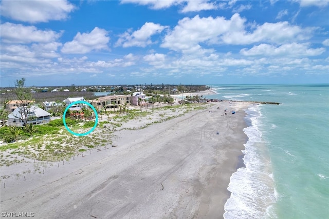 bird's eye view featuring a water view and a view of the beach