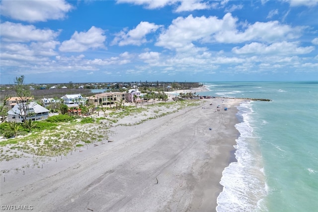 drone / aerial view featuring a water view and a beach view