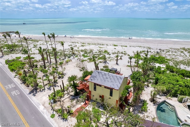 drone / aerial view with a beach view and a water view