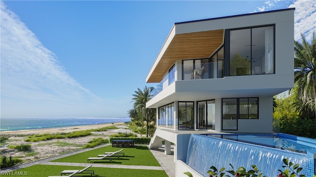 rear view of house featuring a water view, a lawn, and a covered pool