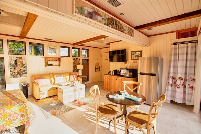 living room featuring beamed ceiling and tile patterned floors