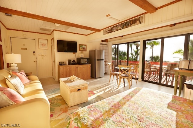 living room with light tile patterned flooring and beamed ceiling