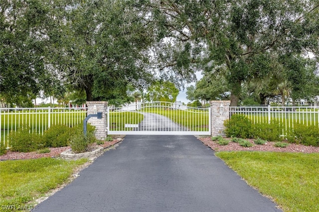 view of gate featuring a lawn