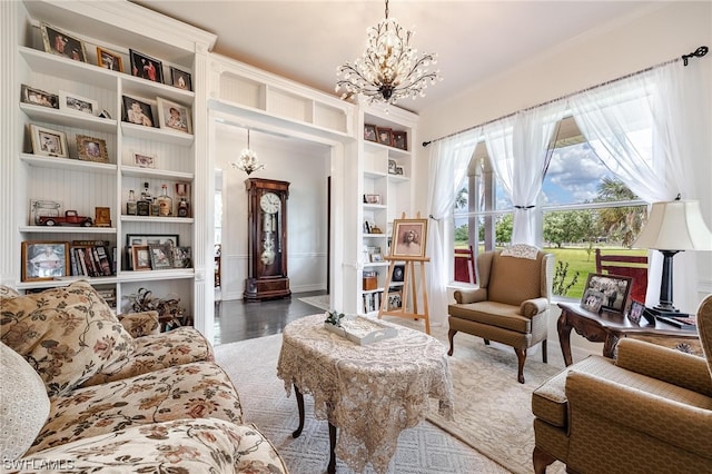 sitting room featuring a chandelier and dark wood-type flooring