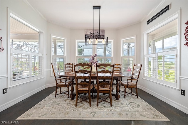 dining space featuring a chandelier, plenty of natural light, crown molding, and dark hardwood / wood-style flooring