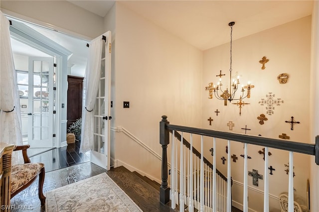 hall featuring a notable chandelier and dark hardwood / wood-style flooring