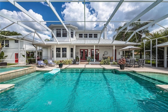 view of swimming pool featuring a lanai and a patio