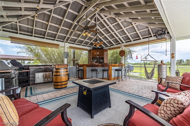 view of patio / terrace with an outdoor bar, ceiling fan, a gazebo, an outdoor hangout area, and exterior kitchen