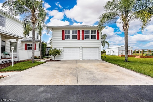 view of front of property featuring a front yard and a garage