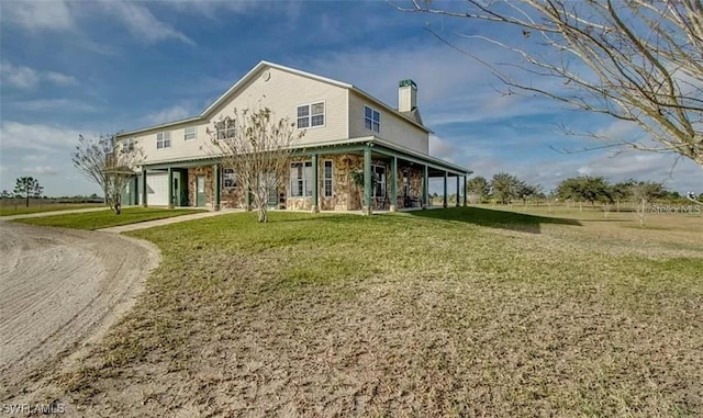 back of house with a lawn