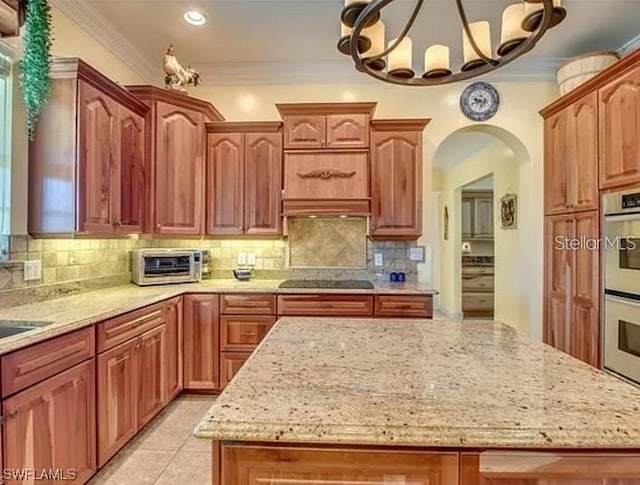 kitchen featuring backsplash, light tile floors, a notable chandelier, and crown molding