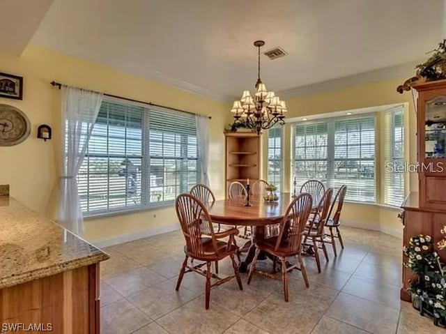 tiled dining room featuring an inviting chandelier