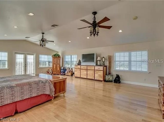 bedroom with lofted ceiling, multiple windows, and light wood-type flooring