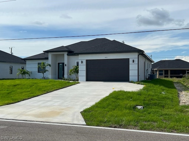 view of front of house featuring central AC unit, a front yard, and a garage