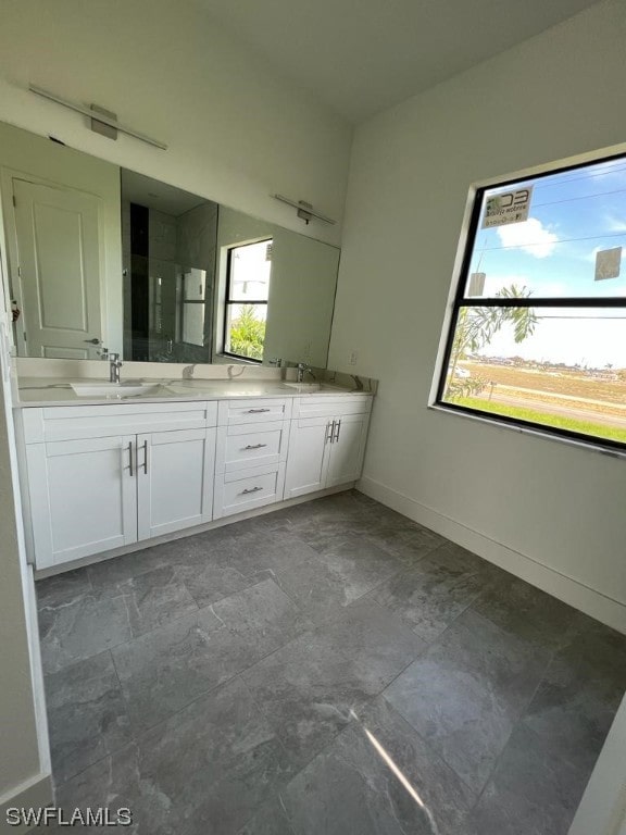 bathroom featuring double sink, tile floors, and vanity with extensive cabinet space