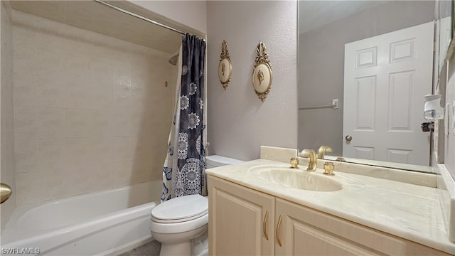 full bathroom featuring shower / bath combo, vanity, and toilet