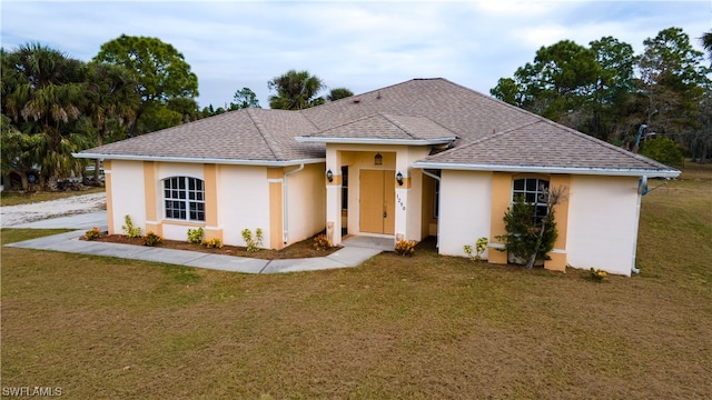 ranch-style house featuring a front lawn