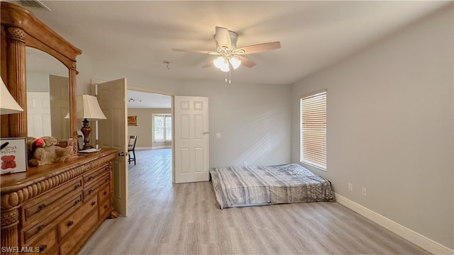 bedroom with light hardwood / wood-style floors and ceiling fan