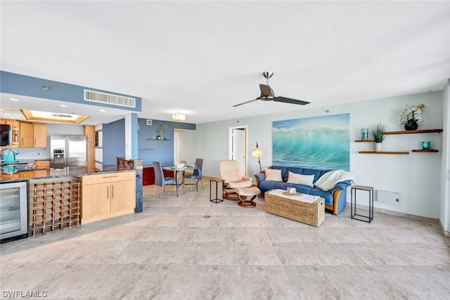 living room featuring ceiling fan and beverage cooler