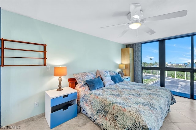 tiled bedroom featuring ceiling fan