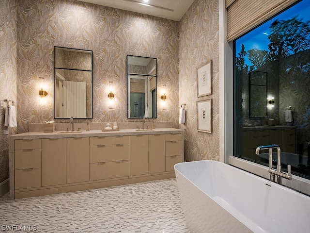 bathroom featuring a bath to relax in, tile floors, and dual bowl vanity