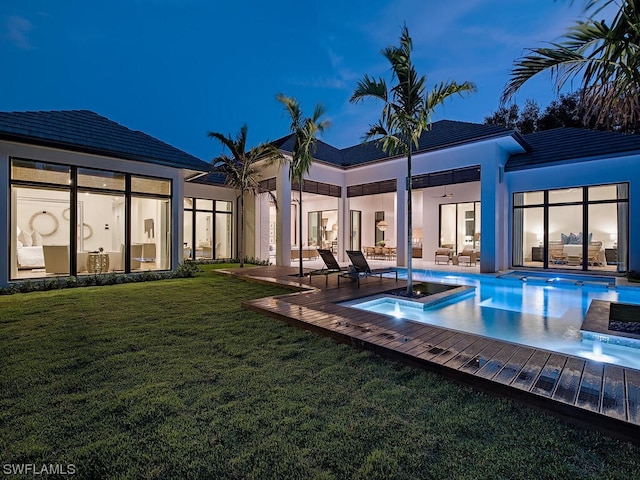 rear view of property featuring a yard and a patio area