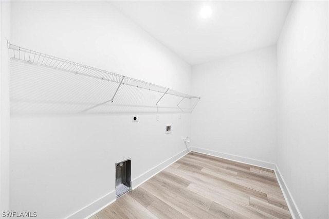 laundry area featuring hookup for an electric dryer, hookup for a gas dryer, light wood-type flooring, and washer hookup