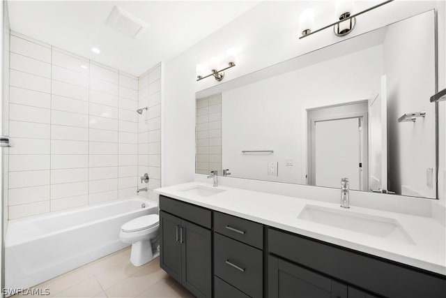 full bathroom featuring vanity, tile patterned floors, tiled shower / bath combo, and toilet