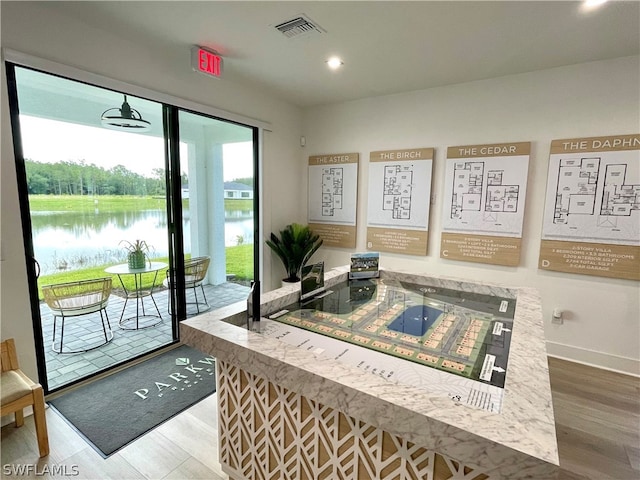 interior space featuring hardwood / wood-style flooring and a water view