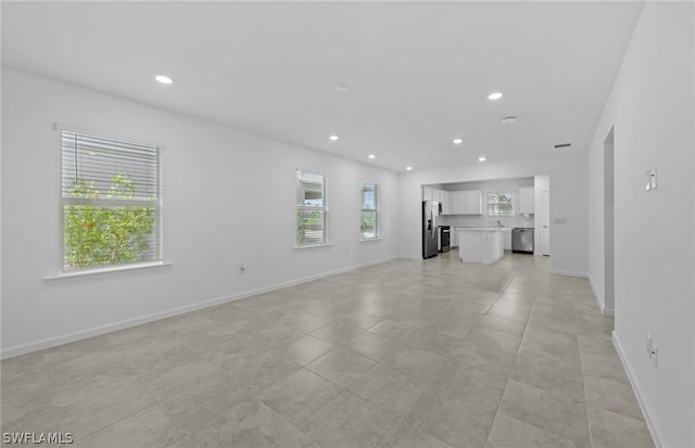 unfurnished living room featuring light tile flooring