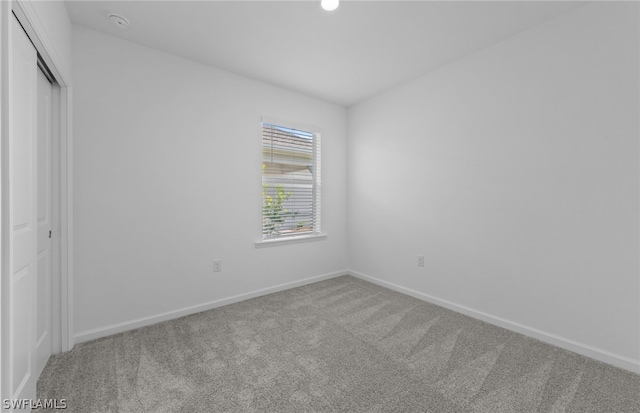 unfurnished bedroom with a closet and carpet